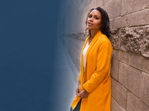 Adrienne Bankert leaning on a wall
