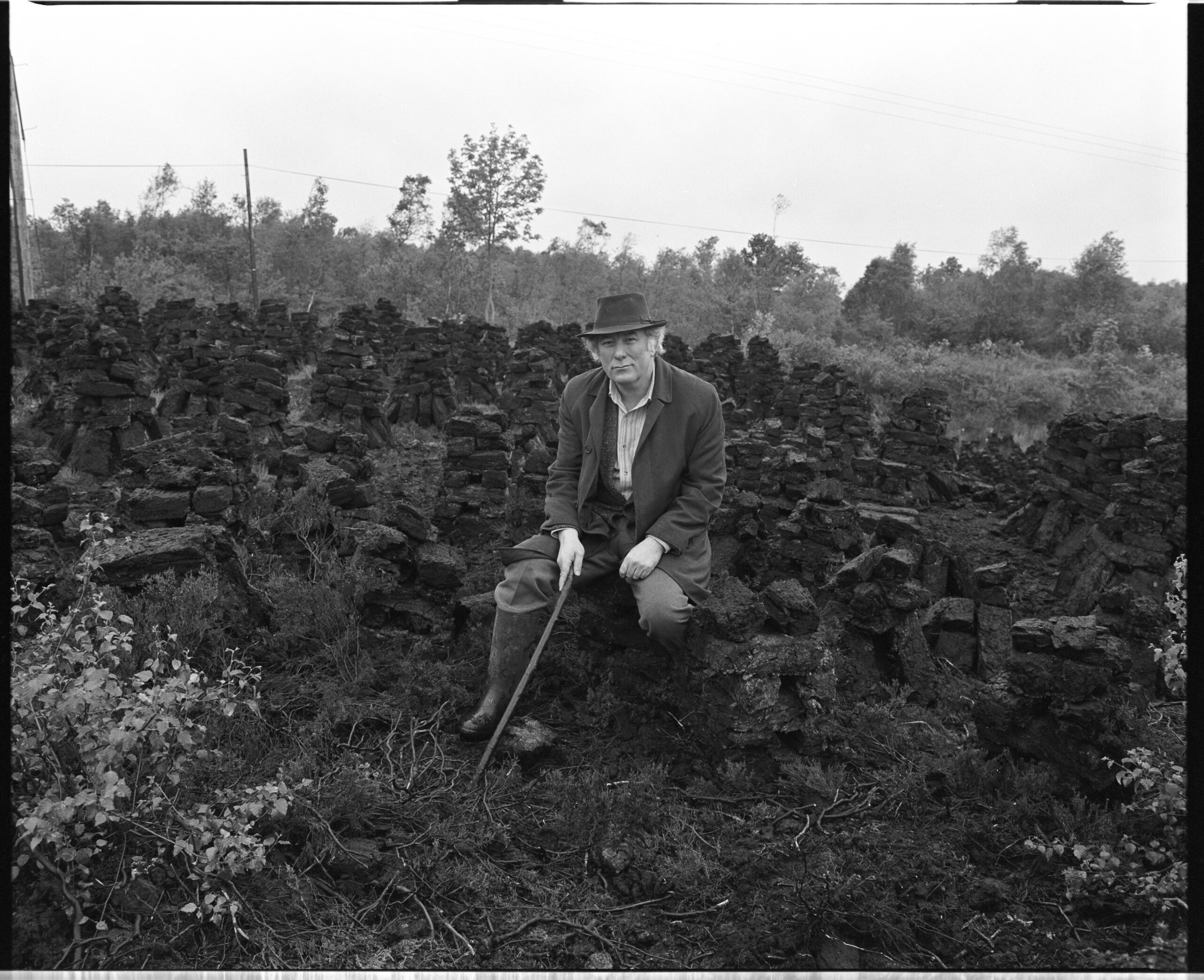 Seamus Heaney at a turf bog in Bellaghy, Northern Ireland, photo courtesy of the Bobbie Hanvey archives at Boston College