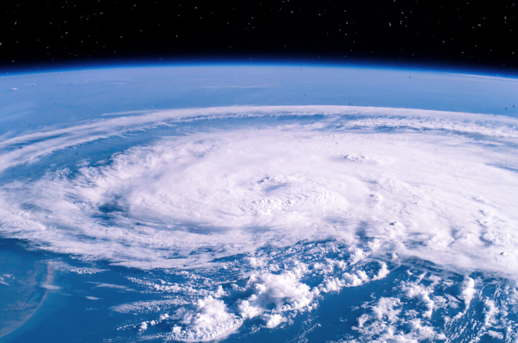 A NASA image of a massive swirling hurricane viewed from space.