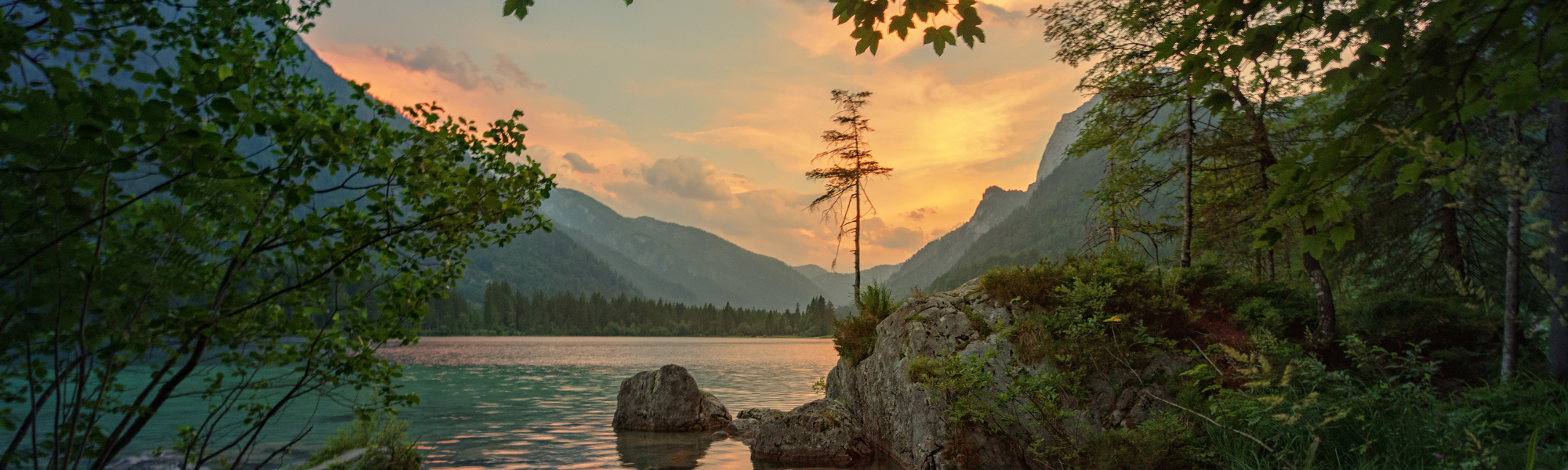 Decorative header image of a lake and valley