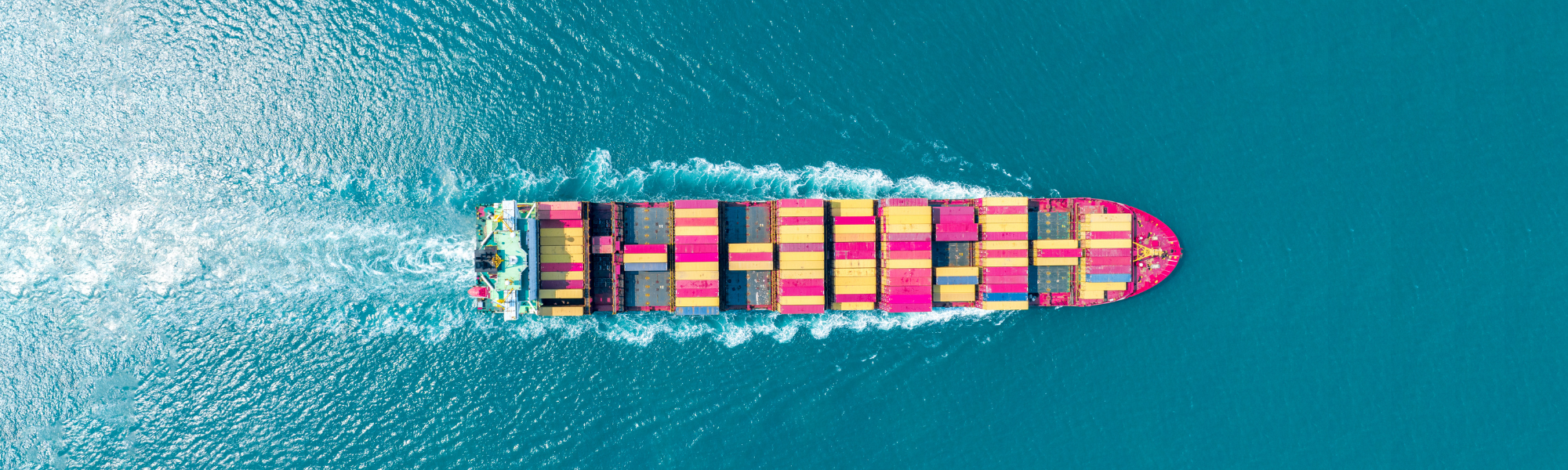 decorative header image; aerial image of a cargo ship in the water