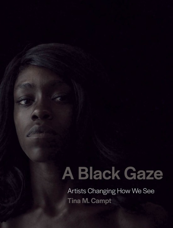 Cover of A Black Gaze, featuring a photo of a Black woman facing the camera with her chin slightly raised. Her face is dimly lit from the left, shrouding the rest of her face and body in darkness.