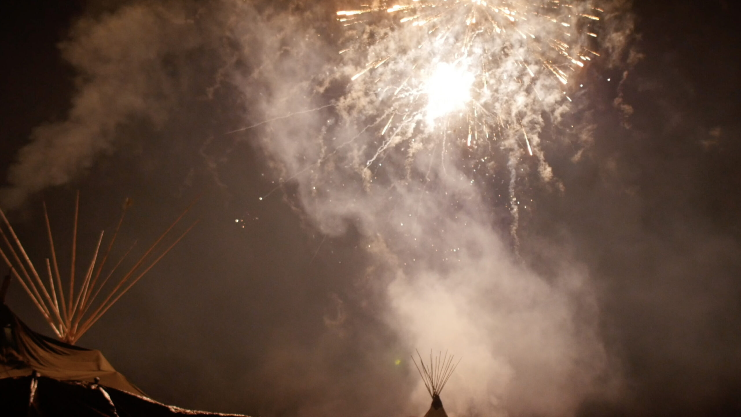 Fireworks over teepees.