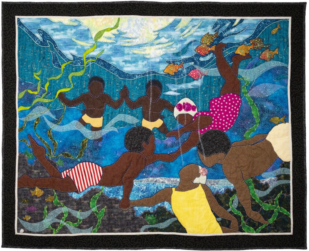 Quilt: Six Black children swim among seaweed and brightly colored fish.