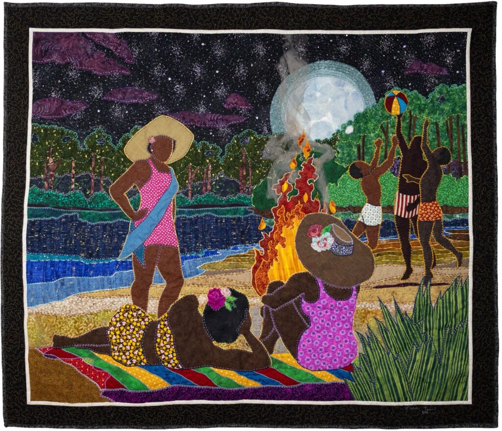 Quilt: A Black beauty queen stands with her friends on the evening beach. In the background, a bonfire burns and three boys play with a beachball.
