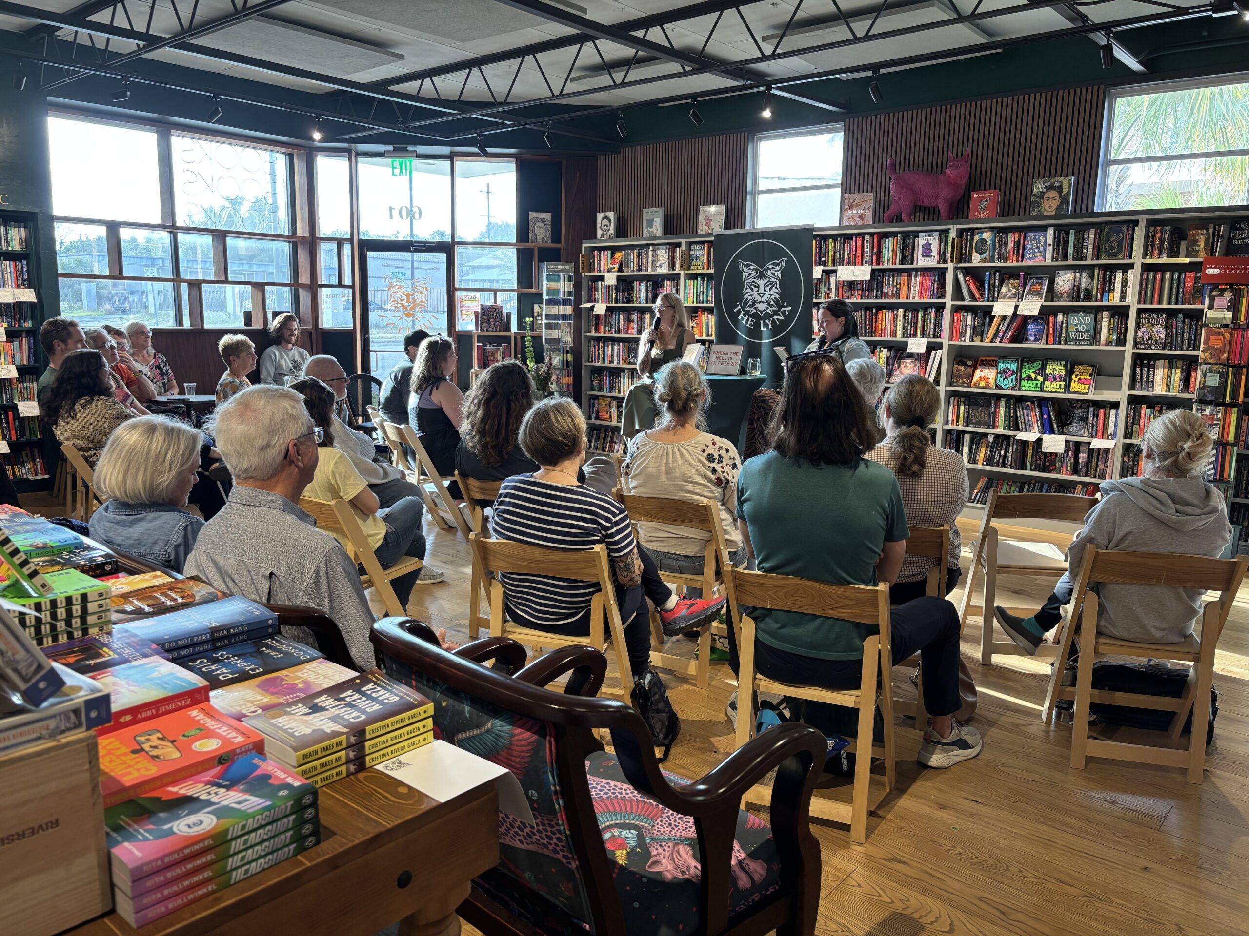 A crowd is seated in a bookstore for Rachel Knox's conversation with Carlynn Crosby.