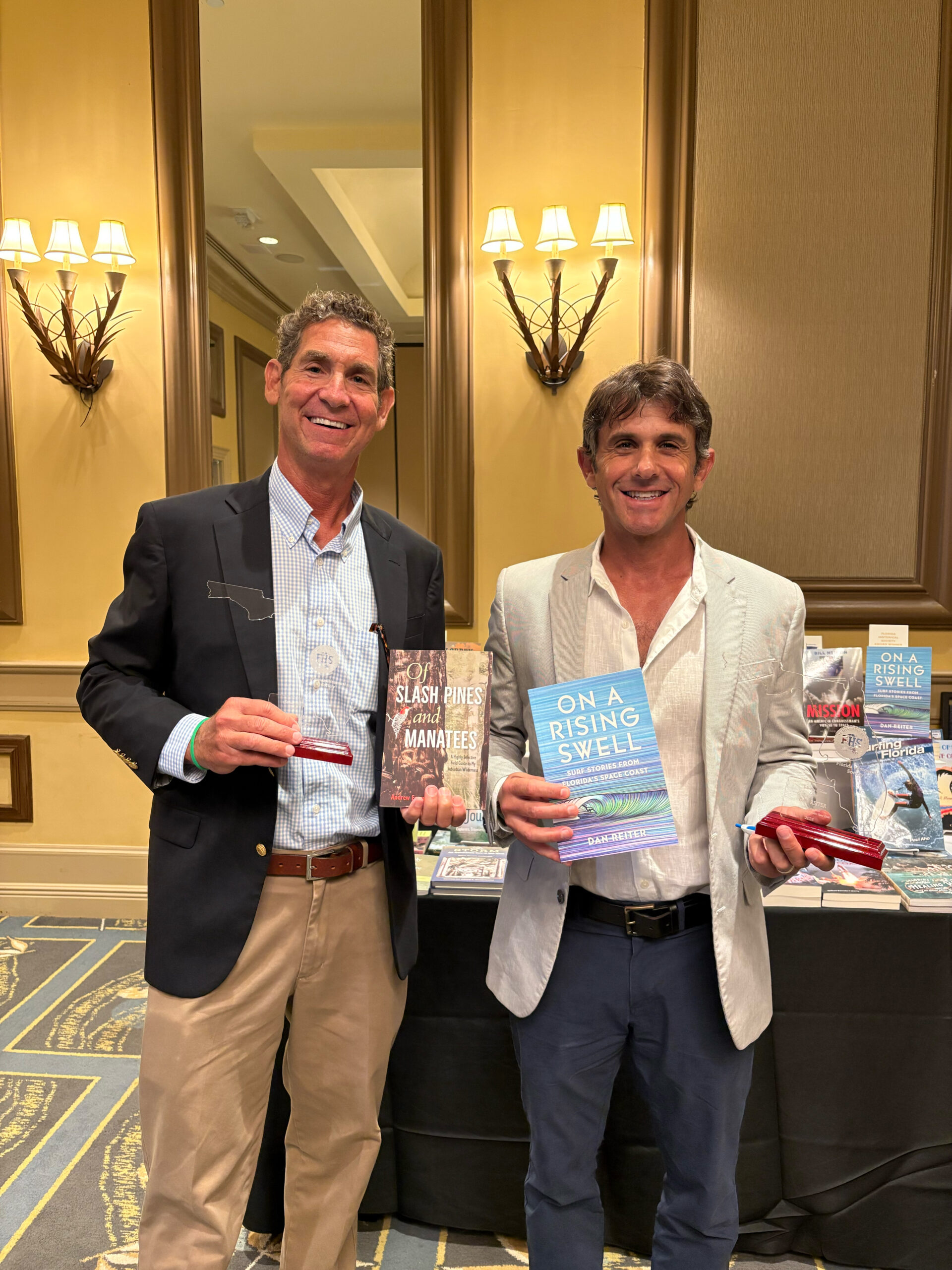 Andrew Furman and Dan Reiter pose with their respective books and awards.